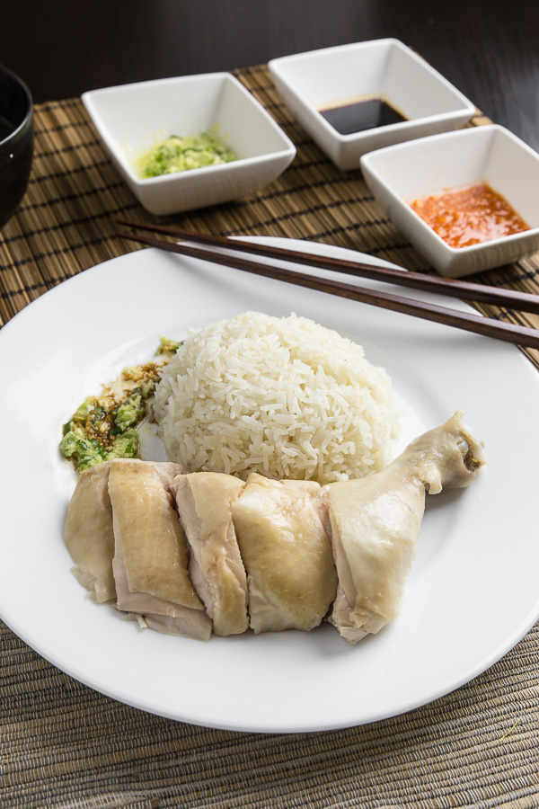 Make this simplified Hainanese chicken rice recipe at home. Moist Hainan chicken, 3 flavorful sauces, fragrant "oily rice". Singaporean classic comfort food. 