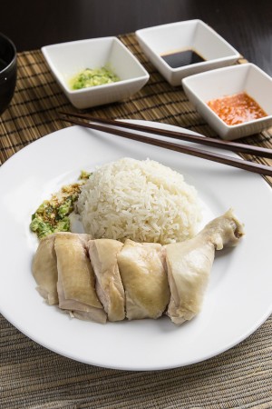 Make this simplified Hainanese chicken rice recipe at home. Moist Hainan chicken, 3 flavorful sauces, fragrant "oily rice". Singaporean classic comfort food.