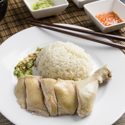 Make this simplified Hainanese chicken rice recipe at home. Moist Hainan chicken, 3 flavorful sauces, fragrant "oily rice". Singaporean classic comfort food.
