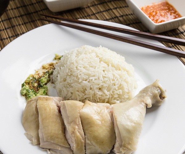 Make this simplified Hainanese chicken rice recipe at home. Moist Hainan chicken, 3 flavorful sauces, fragrant "oily rice". Singaporean classic comfort food.